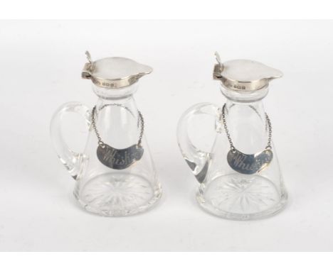 Hukin & Heath Ltd. pair of whiskey tots with silver mounts, Birmingham 1916 and a pair of whiskey labels, by Hukin & Heath Bi