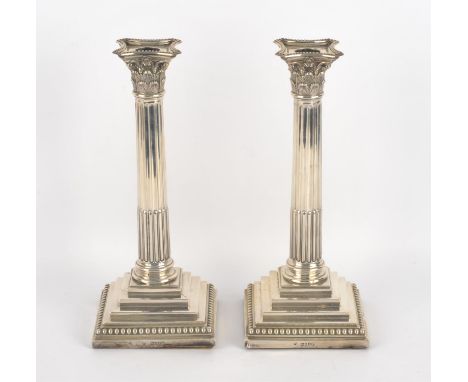 Pair of Victorian Corinthian column candlesticks on stepped bases by Rupert Favell, London 1884, 28cm  loaded bases. Conditio