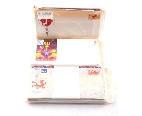 Stamps. In a box containing Australia pre-paid air letters and aerogrammes. Nauru presentation packs, Christmas Islands first