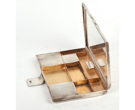 Engine turned French silver vanity / makeup case, the hinged cover fitted with a mirror, the base with three lidded and six o