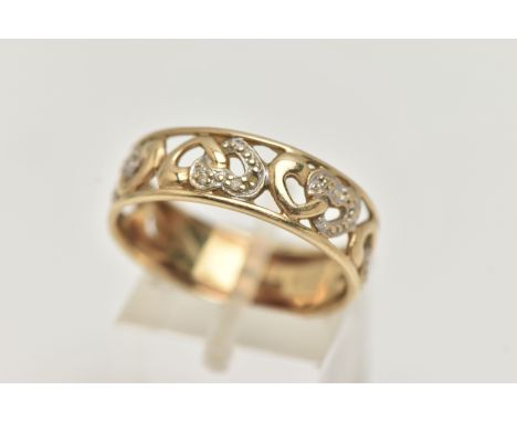 A 9CT GOLD BAND RING, open work wide band, detailed with hearts set with single cut diamond accents, approximate band width 6