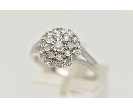 A WHTE METAL DIAMOND CLUSTER RING, circular cluster set with round brilliant and single cut diamonds, to the bifurcated shoul