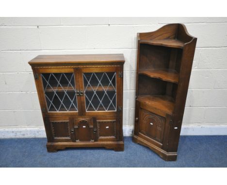 A 20TH CENTURY OAK BOOKCASE, the double lead glazed doors enclosing a single shelf, above two cupboard doors, width 84cm x de