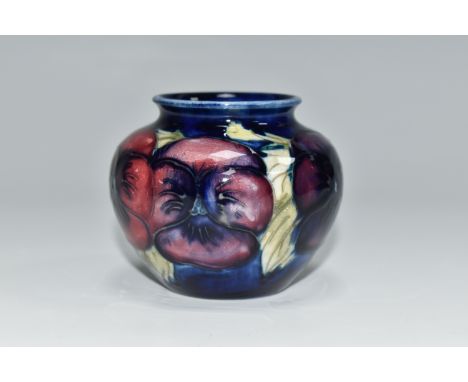 A MOORCROFT POTTERY 'BLUE PANSY' PATTERN SMALL BULBOUS VASE, purple and blue pansies on a dark blue ground, impressed marks t