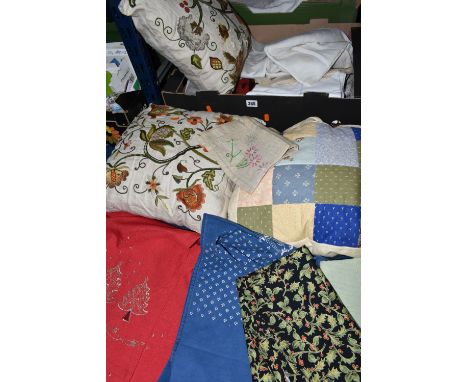 TWO BOXES OF TABLE LINEN AND CUSHIONS, to include two hand embroidered cushions, a patchwork cushion, a white vintage bedspre