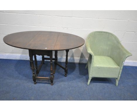 A 20TH CENTURY OAK OVAL GATE LEG TABLE, open width 137cm x depth 92cm x height 76cm, along with a green painted wicker chair 