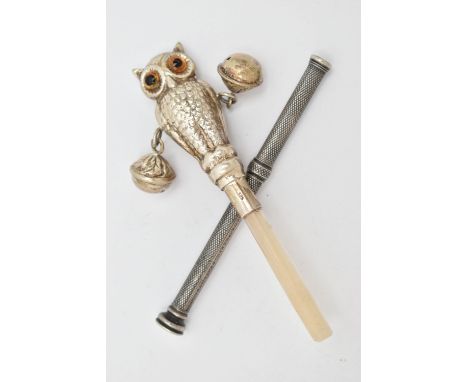 A BABY RATTLE AND A PROPELLING PENCIL, the rattle in the form of a realistically textured owl with orange glass eyes, rubbed 