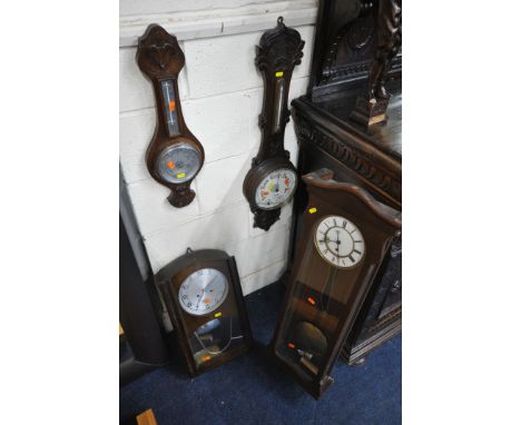 A 20TH CENTURY OAK ANEROID BAROMETER, with foliate detail, the thermometer sitting above a 7.5 inch dial, another barometer a