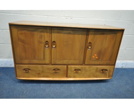 A MID-CENTURY ERCOL ELM WINDSOR ROLLING SIDEBOARD, fitted with three cupboard doors, right hand door enclosing a single drawe