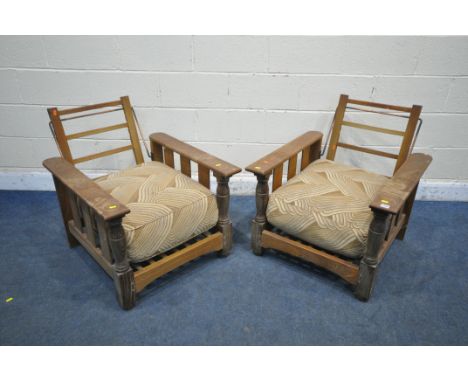 A PAIR OF ERCOL OAK LOW ARMCHAIRS, with a height adjustable back rest, width 71cm x depth 88cm x height 75cm (condition repor