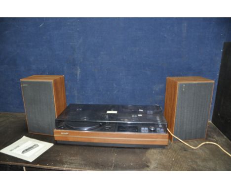 A VINTAGE SHARP SG-315E MUSIC CENTRE with matching speakers (PAT pass and working but tape player doesn't turn)
