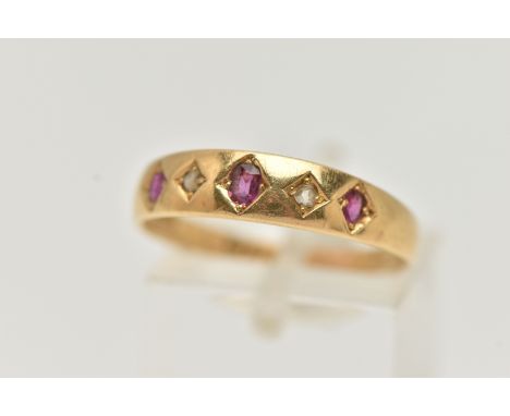 A LATE VICTORIAN YELLOW METAL, RUBY AND DIAMOND RING, designed with a row of three circular cut rubies, and two small rose cu