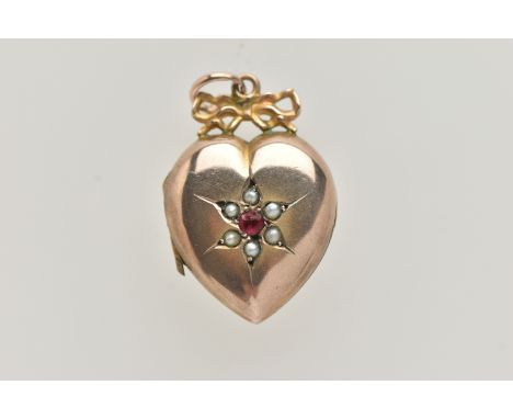 A YELLOW METAL HEART SHAPE LOCKET PENDANT, polished heart with ruby and split pearl detail, stamped to the reverse 'real gold