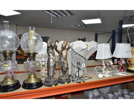 A GROUP OF TABLE LAMPS, comprising two Victorian oil lamps with clear glass reservoirs, a pair of bronzed metal figural lamp 