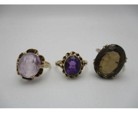 A small collection of dress rings, to include two 9 ct gold and amethyst rings and a brown topaz ring with yellow metal shank