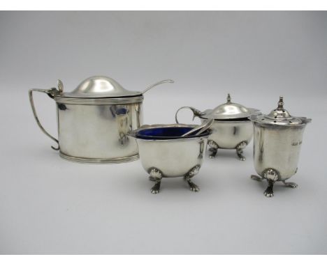 A George V silver three piece cruet set by Thomas William Lack, London 1933, comprising a lidded mustard pot with blue glass 