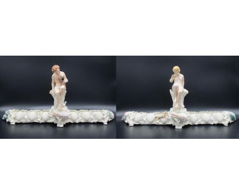 A pair of Victorian Royal Worcester centrepiece vases by Philips and Pearce, each in a trough style, one modelled with a nude