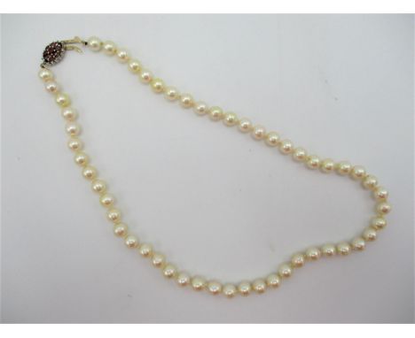 A single strand cultured pearl necklace with diamond, ruby and 9ct gold clasp, comprising 54 uniform pearls, 46.5 cm long 
