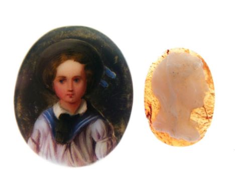 Oval painted porcelain panel of a child in sailor suit, 26mm high and a carved oval cameo of a female profile portrait, 18mm 