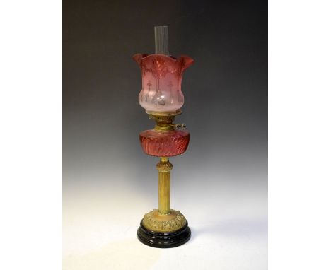 Victorian brass oil lamp having cut cranberry glass reservoir with frosted etched pink shade, overall height including funnel