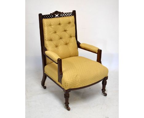 Victorian mahogany framed open arm upholstered button back armchair fitted ceramic castors  