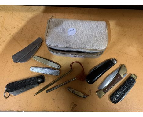 A VINTAGE ZIPPED CASE CONTAINING A NUMBER OF PEN KNIVES 