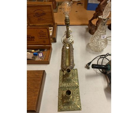TWO BRASS CANDLESTICKS, A BRASS LAMP BASE AND A VINTAGE BRASS DESK ACCESSORY 