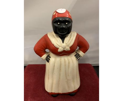 A VINTAGE CAST IRON MONEY BOX IN THE FIGURE OF A WOMAN 