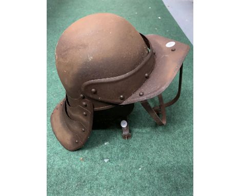 A VINTAGE METAL HELMET WITH FACE GUARD 