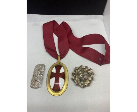 THREE ITEMS TO INCLUDE TWO DECORATIVE BROOCHES POSSIBLY SILVER AND AN ENAMEL CROSS OF ST GEORGE ON A RIBBON 