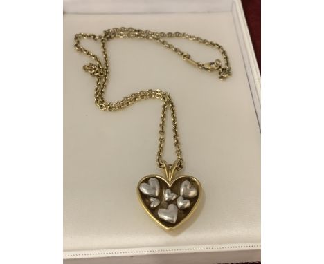 A SILVER MARKED 925 GOLD PLATED CHAIN WITH HEART SHAPED PENDANT ENCOMPASSING SILVER HEART DETAIL, DESIGNED BY BOBBY WHITE IN 