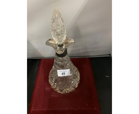 A CUT GLASS DECANTER INCORPORATING A HALLMARKED SILVER CUFF 