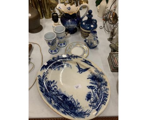 A COLLECTION OF BLUE AND WHITE CERAMIC WARE TO INCLUDE A LARGE JUG, A SERVING PLATTER AND A 'LAMBS NAVY RUM' BOTTLE ETC 