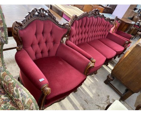 A HEAVILY CARVED MAHOGANY THREE SEATER SOFA AND TWO MATCHING ARMCHAIRS 