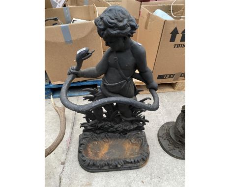 AN ORNATE CAST IRON STICK STAND WITH A BOY AND SNAKE DECORATION 