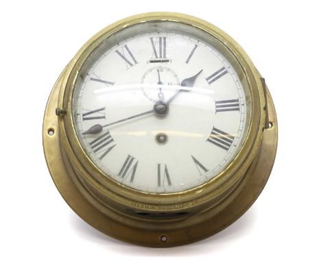 A brass ships clock early 20th century, the white enamel dial with Roman numerals and subsidiary seconds dial,18.5cm diameter