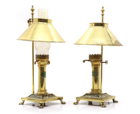 A pair of brass 'Orient Express' table lamps 20th century, each with a conical shade, over a plain column labelled 'Paris Ori