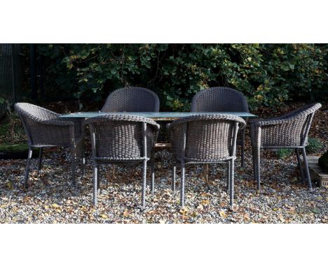 An Art Deco wrought iron garden table, 20th century, with a later glass top, 85cm wide 180cm long, andsix modern wicker garde