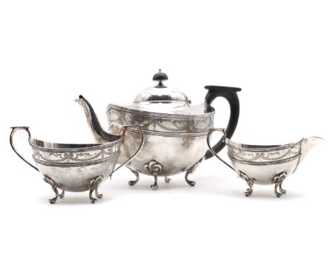 A silver three piece tea service by William Aitken, Birmingham 1921, comprising a teapot, 26cm wide, twin-handled suagr bowl,