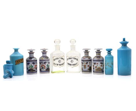 A graduated group of three opaline glass apothecary bottles  19th century, with three associated stoppers,  the largest 24cm 