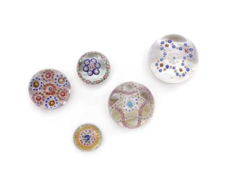 A group of four French glass paperweights,  mid-19th century, comprising three Baccarat garland paperweights, and a miniature