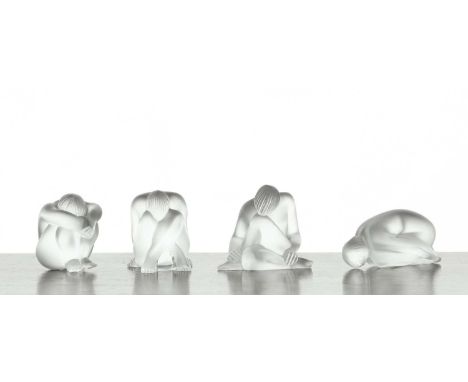 A group of four Lalique glass figures to include 'Nu Feuille Pliee', 'Nu Nahbi', and 'Nu Assis', engraved signatures, complet