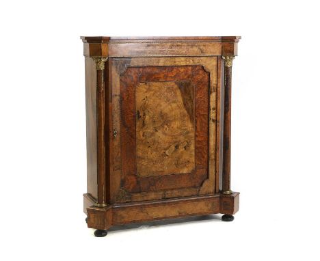 A marquetry inlaid gilt metal mounted pier cabinet 19th century, the single panelled door inlaid with foliate scrolls, flanke