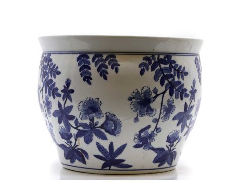 A blue and white fish bowl  20th century, painted with flowering trees, 40cm diameter 31cm high, together with a pair of Chin