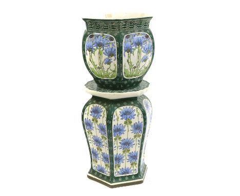 An Art Nouveau Mintons pottery jardinière on stand  c.1880, with blue flowers, to a green ground, impressed marks, the stand 