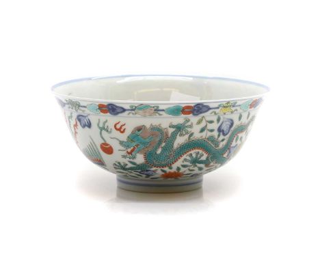 A Chinese wucai bowl, 20th century, of circular form with a flared rim, painted with dragons and phoenixes chasing flaming pe