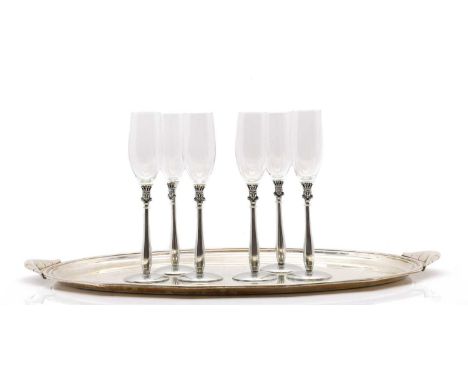 An Art Deco silver plated oval two handled tray with an angled border75cm wide together with a set of six modern Champagne fl