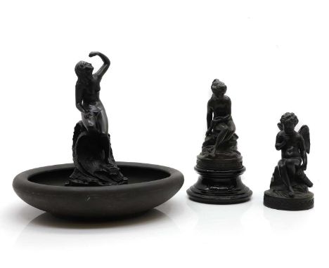 Two Wedgwood black basalt figures, 19th century and later, comprising; a figure of Cupid sitting upon a rock with a quiver, 2