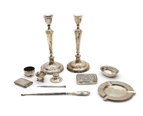 A collection of silver items comprising a pair of candlesticks, 23cm high, a Portuguese ashtray, 13cm wide, a Victorian boot 