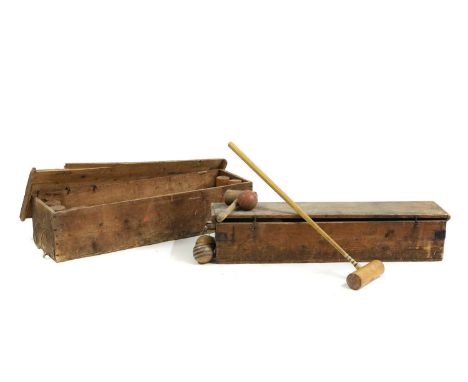 A boxed croquet set,  early 20th century, 105cm wide 31cm deep together with a cased set of skittles  102cm wide 24.5cm deep 